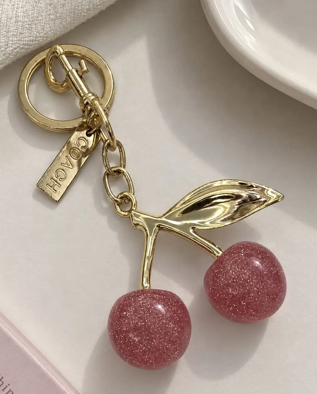 COACH CHERRY BAG CHARM ROSA